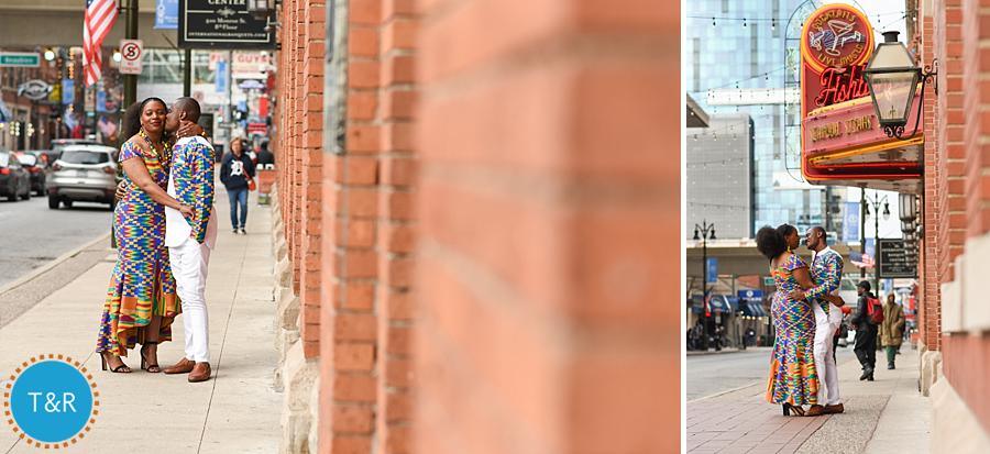 A couple embraces on the sidewalk in Detroit's Greektown wearing colorful African outfits