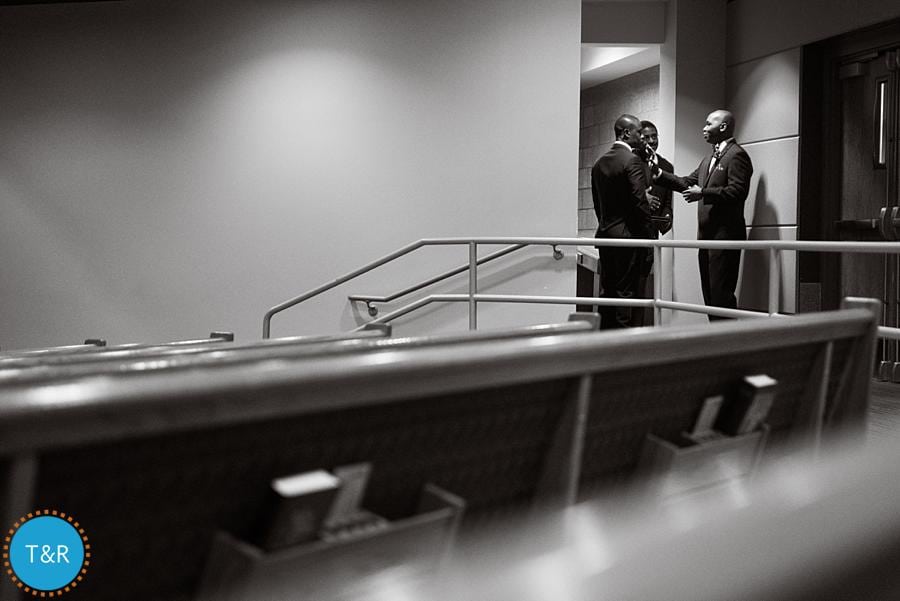 A groom recieves advice from a groomsmen before his wedding at Detroit's Tabernacle Missionary Baptist Church