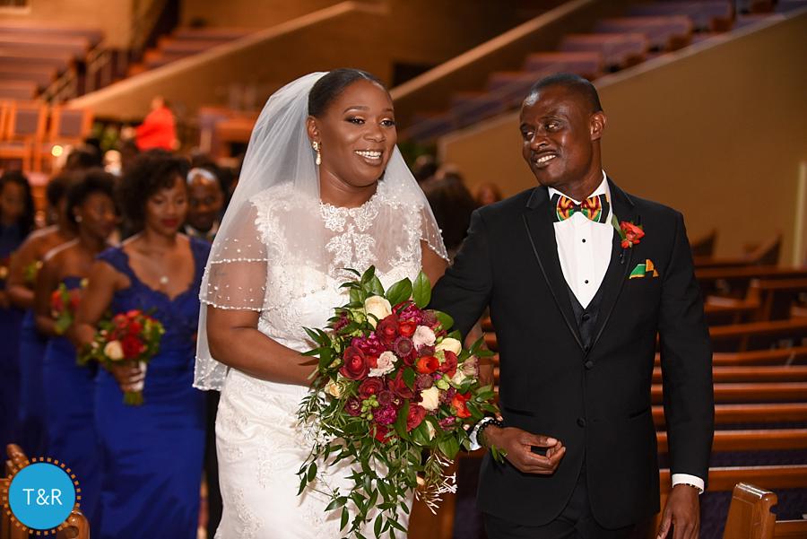 A couple is all smiles as they walk up the aisle after being married