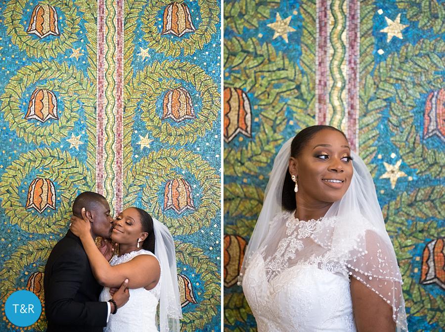 A newly married couple embraces in front of a colorful wall at Detroit's Fisher building