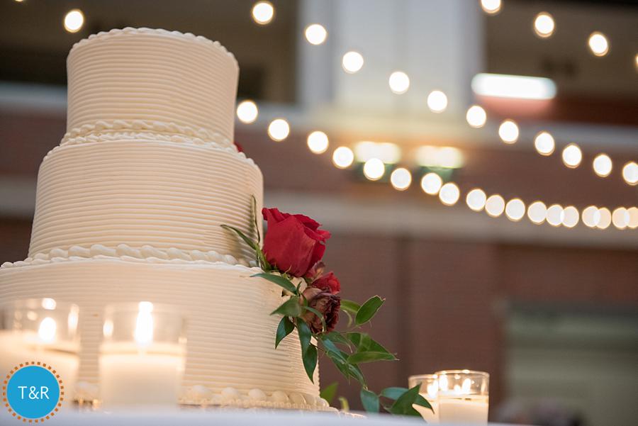 A beautiful wedding cake with twinkling lights in the background at Detroit's Rattlesnake club