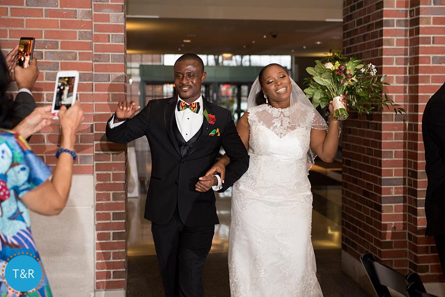 A couple smiles as they are introduced into their wedding reception at Detroit's Rattlesnake club