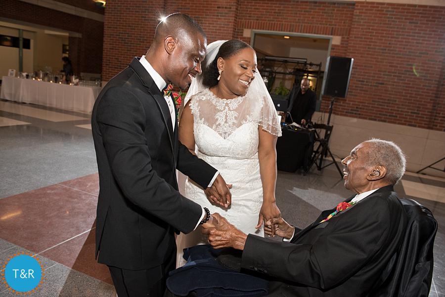 A couple is all smiles while dancing with the brides grandfather at The Rattlesnake club