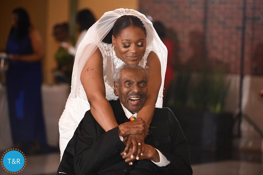 A bride embraces her grandfather during a wedding reception dance at the Rattlesnake club