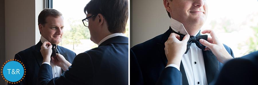 Detail shot of the groom tying his tie