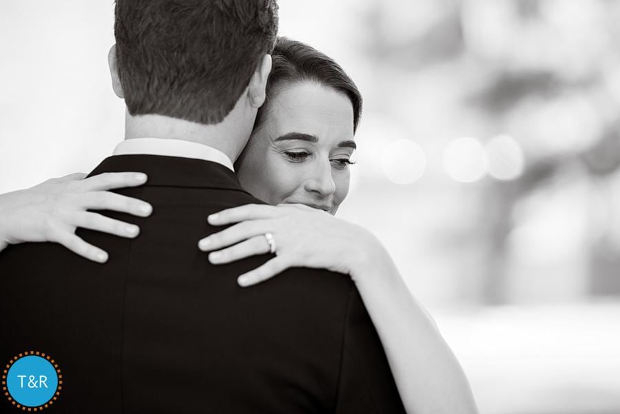 The bride and groom hugging