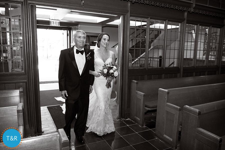 The father of the bride and the bride, walking down the aisle