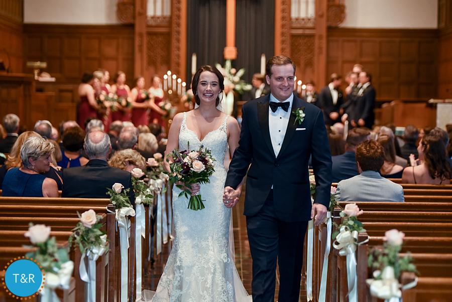 The happy bride and groom existing the church