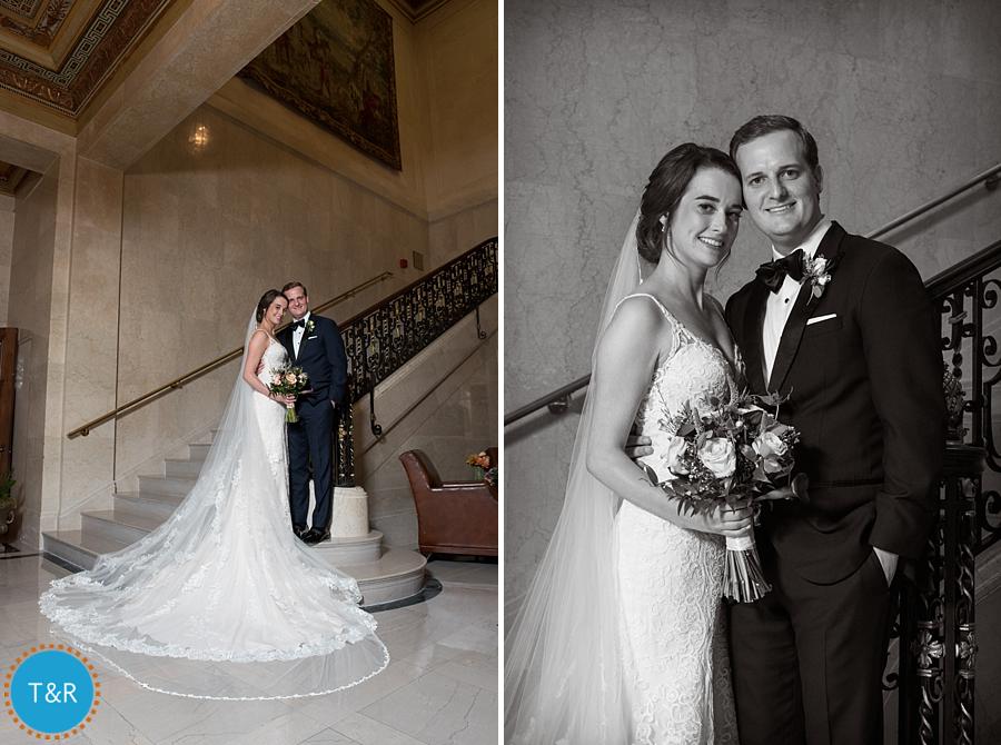 The happy couple, posing on the stairs with a detail shot of the bride's veil
