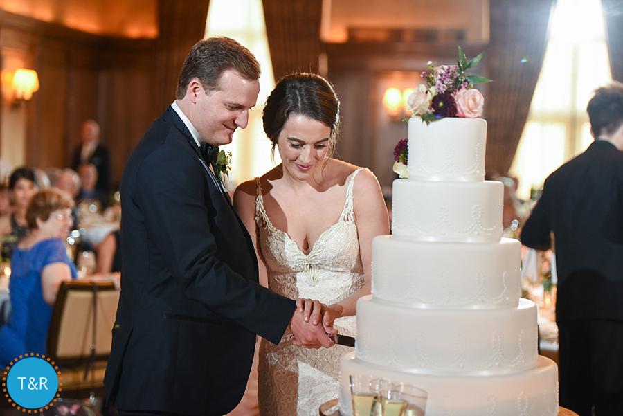 The bride and groom cutting the wedding cake.
