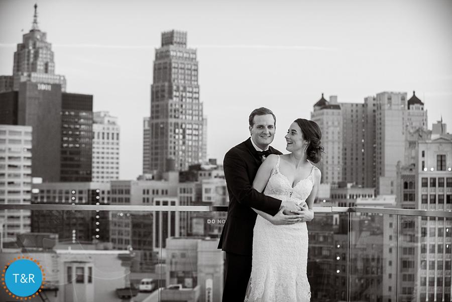 The bride and groom with the Detroit skyline behind them