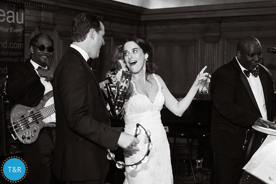 Bride and groom playing tambourine with the band