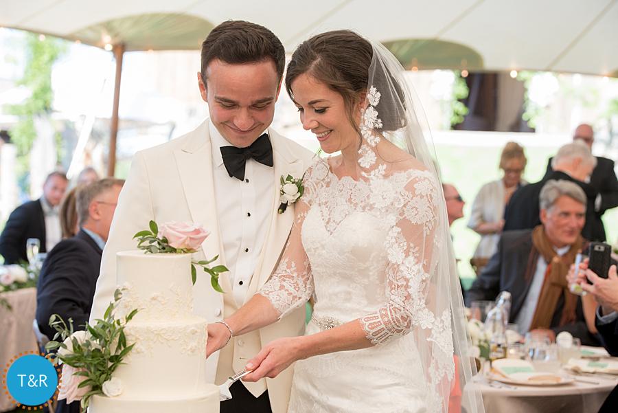 bride and groom cut cake at Misty Farm wedding reception
