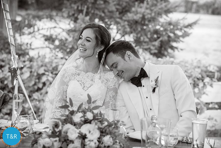 groom leand head on bride's shoulder and laughs
