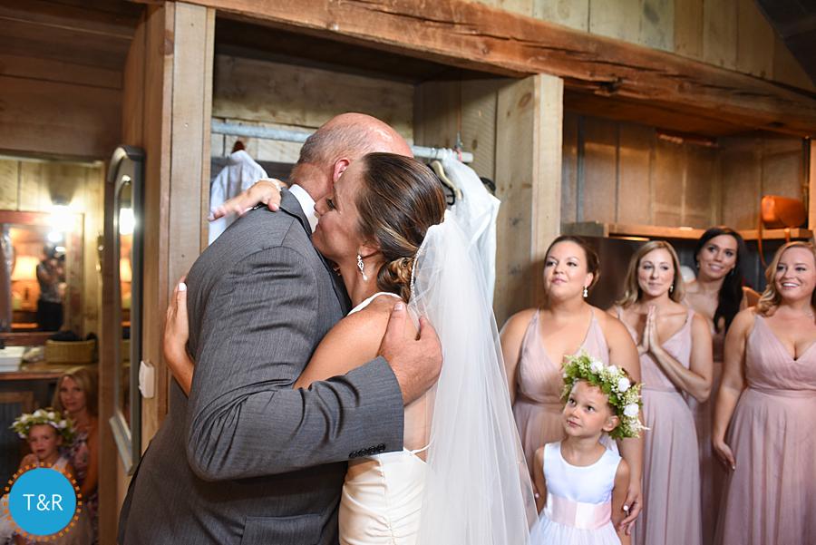 Bride hugs her father surrounded by her bridesmaids at Frutig Farms The Valley in Ann Arbor, MI