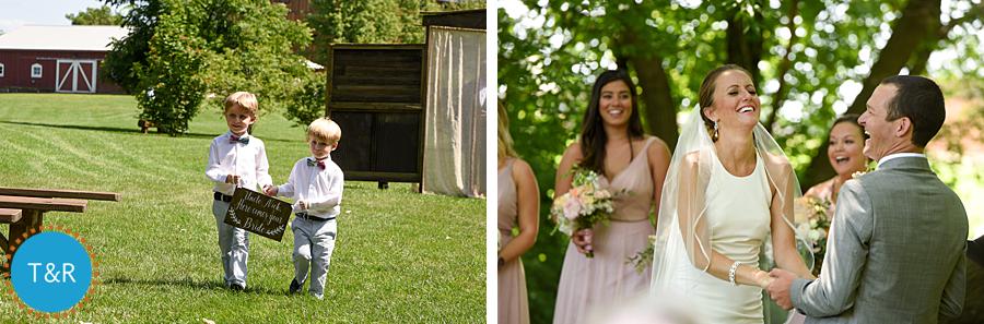 Two small boys carry a sign, and bride and groom laugh at their wedding ceremony at Frutig Farms The Valley in Ann Arbor, MI