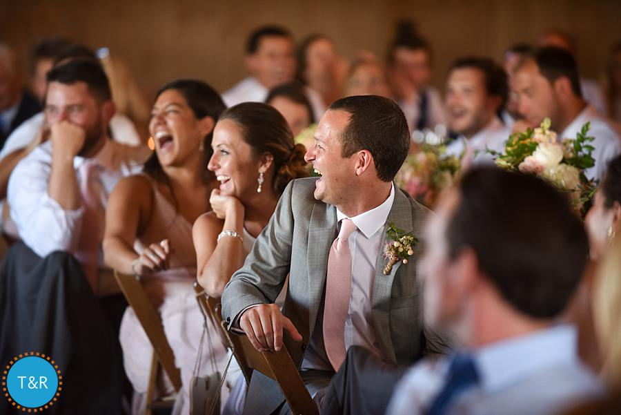 Bride and groom laugh during toasts at their wedding reception at Frutig Farms The Valley
