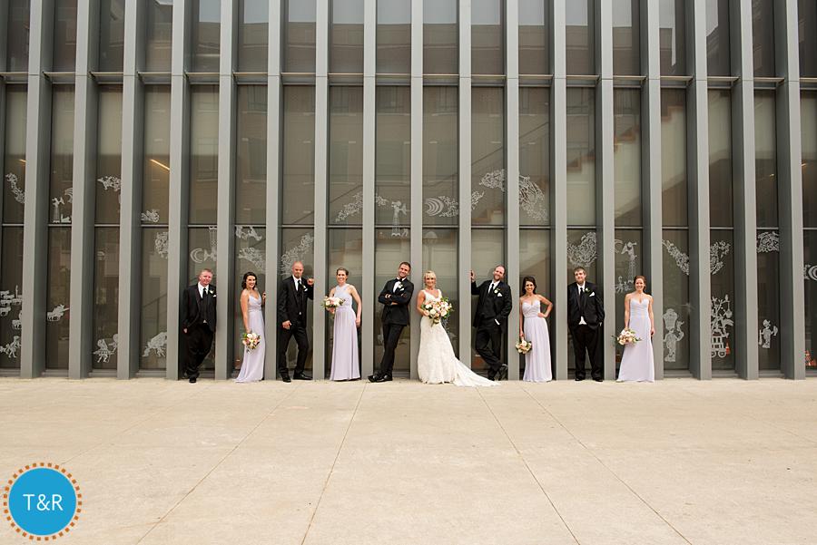 Bride and groom and their bridal party pose for wedding photos at the UMMA in Ann Arbor