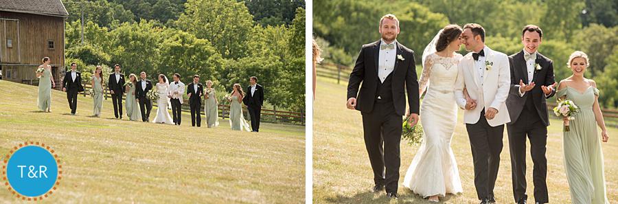 Bride and groom and their bridal party walk and laugh on the grounds of Frutig Farms Misty Farm before their Ann Arbor wedding ceremony