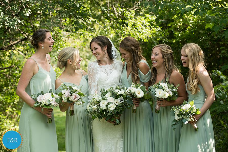 Bride and her bridesmaids laugh together after her Frutig Farms Misty Farm wedding in Ann Arbor