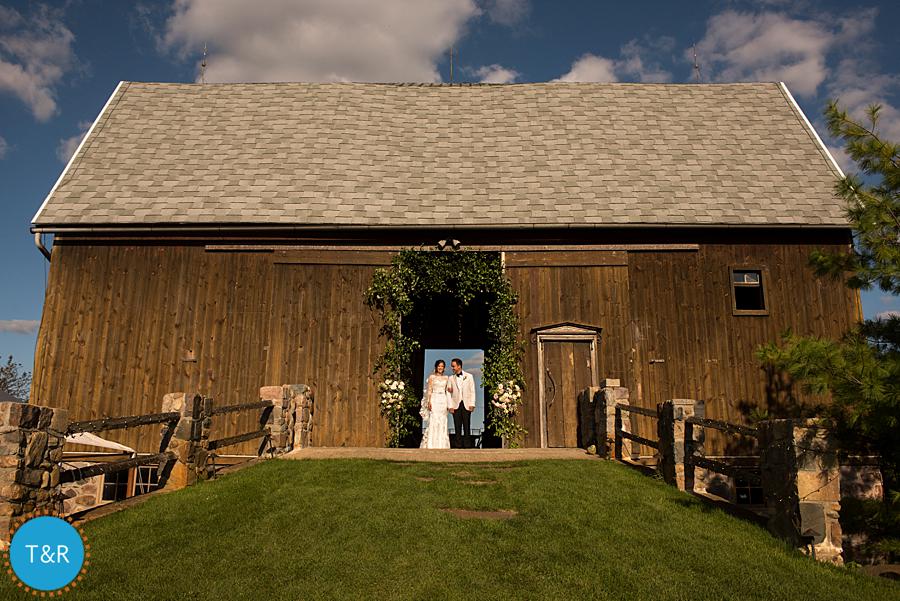 Bride and groom in the doorway of the barn at Frutig Farms Misty Farm after their Ann Arbor wedding ceremony