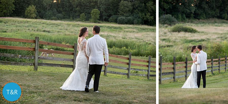 Bride and groom take a walk on the grounds of Frutig Farms Misty Farm during their Ann Arbor wedding reception