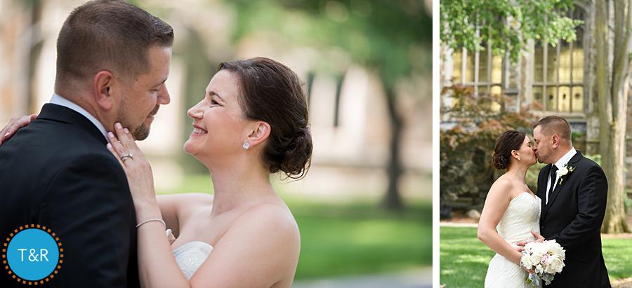 Bride and groom smile and kiss during wedding photos at University of Michigan's Law Quad in Ann Arbor