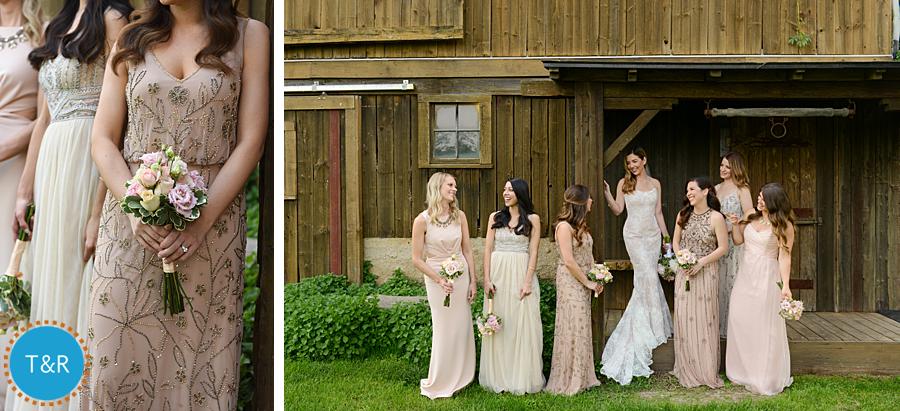 Bride and bridesmaids wearing different shades of bush and pink dresses standing outside the barn at a Frutig Farms Misty Farm wedding